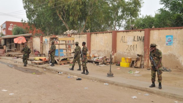 Soldiers at the scene of an explosion at a market in Kano, Nigeria, on Wednesday.