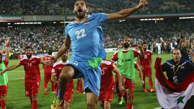 Syria's team celebrates after drawing with Iran in Tehran.