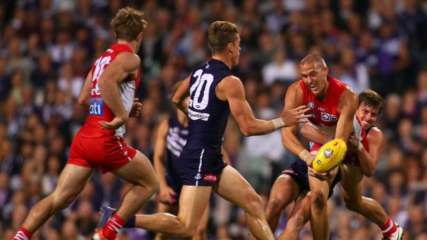 Back in round four: Nick Suban of the Dockers tackles Sam Reid of the Swans.