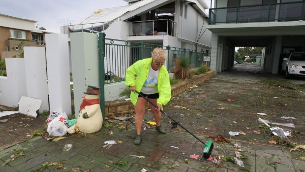 Beverley Bultitude starts the clean up outside her Kurnell home.