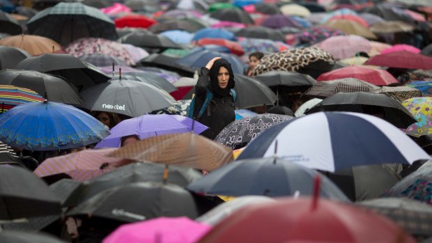 A woman looks from above hundreds of protesters with umbrellas during a massive demonstration against gender violence, at Plaza de Mayo square in Buenos Aires, Argentina, last week.