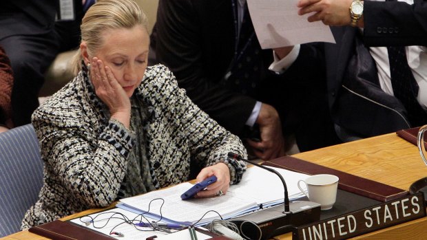 Then-Secretary of State Hillary Clinton checks her mobile phone after her address to the Security Council at the UN headquarters. 