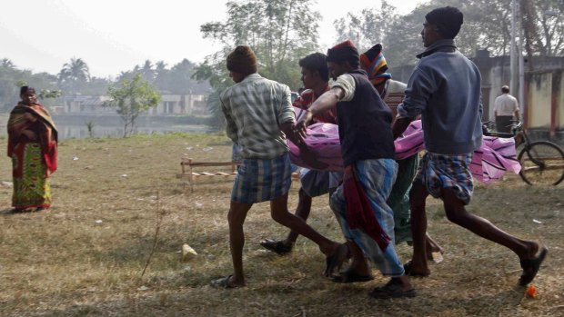 Family members carry the body of a relative who consumed bootleg liquor south of Kolkata in 2011. That batch of bootleg liquor killed at least 100.