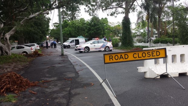 Police set up road blocks around the scene of a police shooting in Ashgrove.