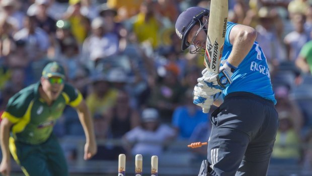 Pressure takes toll: Eoin Morgan watches the bails fly off a Mitchell Johnson delivery.