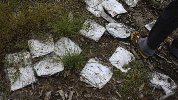 Medical refuse at the site of a now-abandoned crematorium where bodies were burned during the Ebola crisis in Marshall, Liberia.