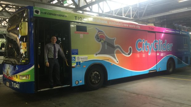 Brisbane City Council's public transport chairman Peter Matic with the Brisbane Pride Festival-themed rainbow bus.