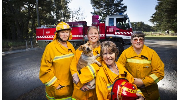 CFA volunteers Carolyn Fennell, Ebony Fennell (with her dog Chloe), Karen Norbury and Debbie Donald at the Kinglake West Fire Station. Ebony is one of the youngest members but a rarity these days as the CFA are finding it hard to recruit younger members.