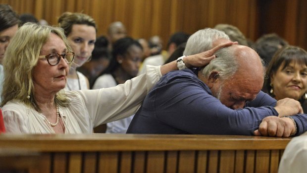 Barry Steenkamp, father of Reeva Steenkamp, is consoled by his wife June  during the sentencing hearing for Oscar Pistorius  in Pretoria in October 2014.
