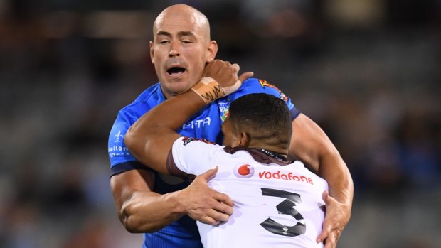 Terry Campese tackles Taane Milne of Fiji.