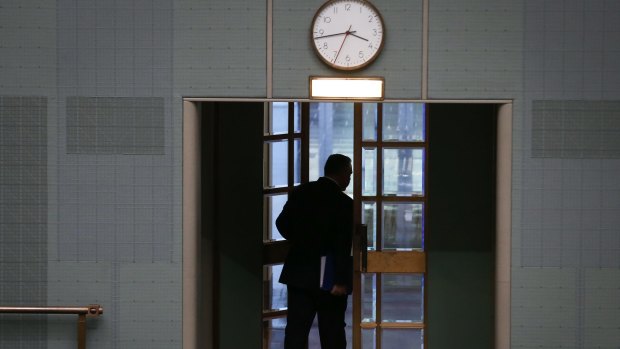 In the shadows: Hockey departs at the end of question time on Tuesday.