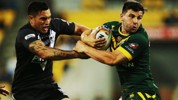 Man of many colours: Josh Mansour, in green and gold, tries to get past Dean Whare of New Zealand during the Four Nations final at Westpac Stadium on November 15, 2014.