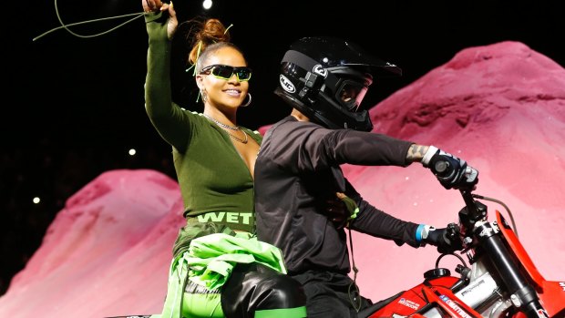 Rihanna rides on a motorcycle after showing her fashion collection from Fenty.