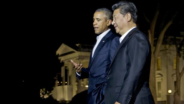 US President Barack Obama and Chinese President Xi Jinping walk on the North Lawn of the White House in Washington on Thursday evening.