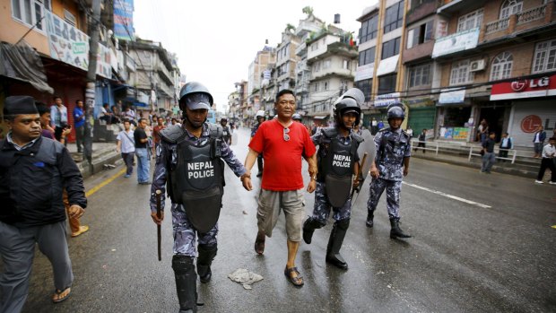 Nepalese police detain a protester during a general strike on Sunday.