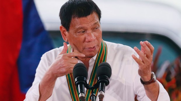 Philippine President Rodrigo Duterte gestures with a firing stance.
