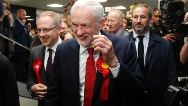 Labour Party leader Jeremy Corbyn smiles after arriving at his constituency in London.