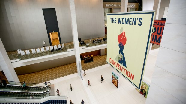 Attendees arrive as signage is displayed during the Women's Convention in Detroit, Michigan.