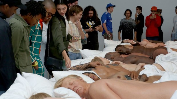 There were 12 in the bed ... visitors admire West's sculpture of naked celebrities including, in foreground, a slumbering Trump.