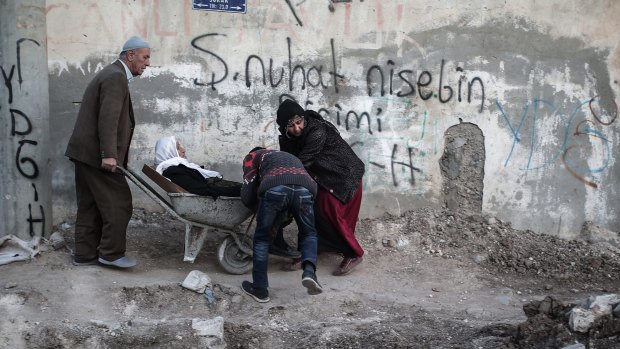 A sick person is carried through barricades set up by  the Kurdistan Workers' Party in Nusaybin on Christmas Eve. 