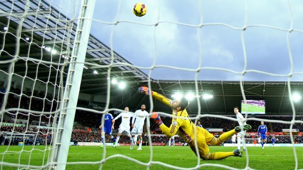 Goal blitz: Oscar of Chelsea scores his team's fourth goal past Swansea's Lukasz Fabianski.