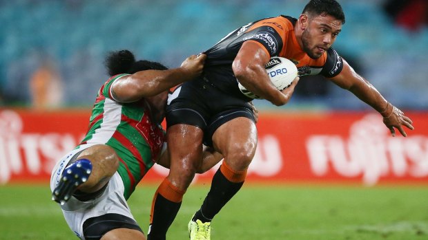 Ratings bonanza: David Nofoaluma of the Tigers is tackled by Siosifa Talakai of the Rabbitohs during the Tigers' victory on Friday night.