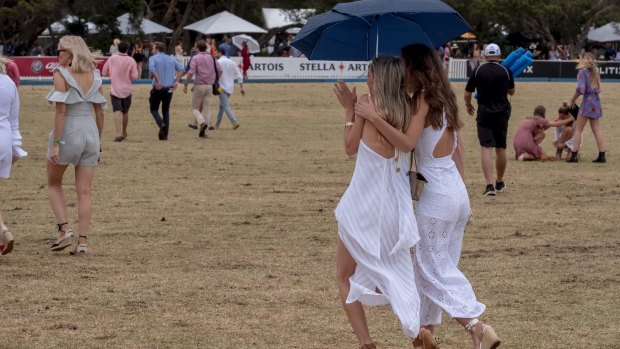 Showers didn't stop the punters from hitting the turf at the polo in Portsea.