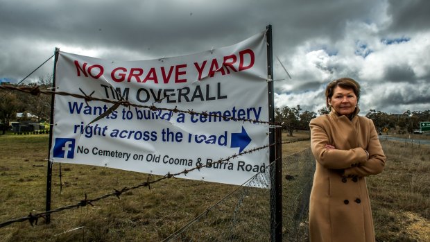 Wendy Hubbard with the sign targeting the proposed cemetery. 