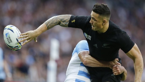 Trademark flick: New Zealand's Sonny Bill Williams passes the ball as he is tackled by Argentina's Juan Imhoff.
