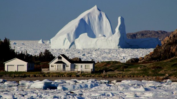 A giant iceberg passes Little Harbour  in Twillingate, Newfoundland and Labrador.