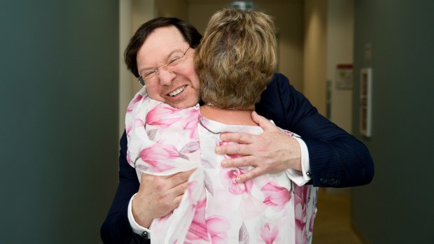 Professor John Rasko gets a hug from Eunice Lee, after her son, Mark, successfully completed a gene therapy trial for haemophilia at the Charles Perkins Centre at RPA in Sydney.  