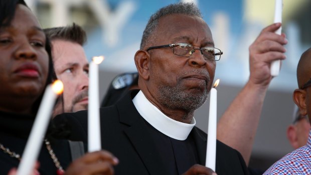 Pastor William McCurdy holds a candle during a prayer vigil in honour of those affected by the shooting on the Las Vegas Strip.