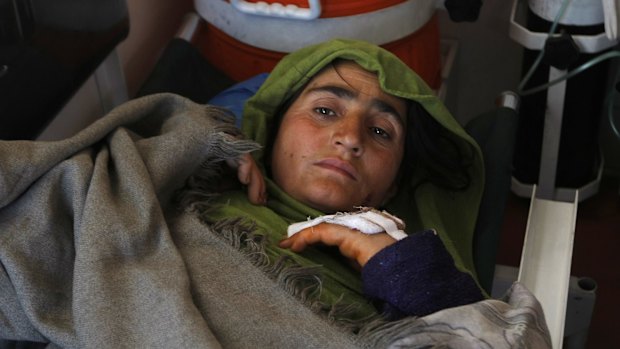 A Pakistani woman injured in Monday's earthquake rests in an ambulance after she was flown from Chitral, at Peshawar airbase in Pakistan, on Tuesday.