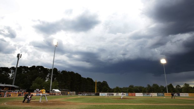 A thunderstorm goes around the Narrabundah Ball Park.