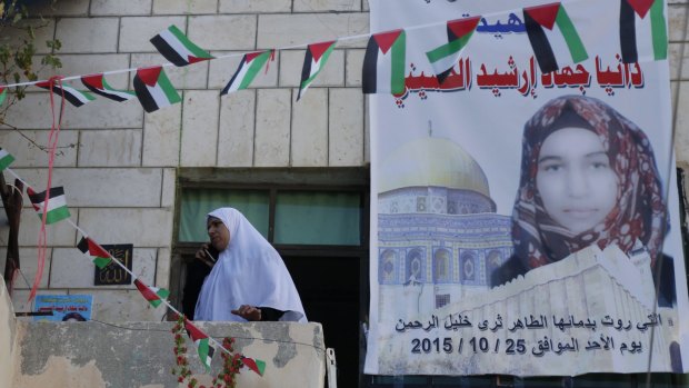 A poster depicts 17-year-old Palestinian Dania Ersheid, shot dead by Israeli border police as she tried to enter the Muslim section of the Hebron shrine, as a martyr "who soaked the soil of Hebron with her pure blood on Sunday, October 25, 2015".