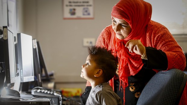 Toorpaikai Baees with her son Arash during a program where Muslim mothers are taught IT skills so they can better understand what kids are looking at online – especially the risk of extremist propaganda.