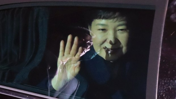 President Park Geun-hye waves to her supporters from her vehicle upon her arrival at her private home in Seoul.
