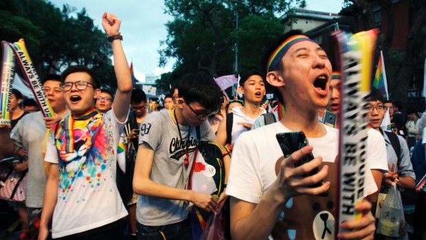 Same-sex marriage supporters cheer outside the Legislative Yuan in Taipei after the Constitutional Court ruled in favour of same-sex marriage.