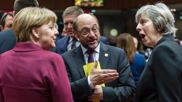 German Chancellor Angela Merkel, left, speaks with British Prime Minister Theresa May, right, and European Parliament President Martin Schulz, centre, in Brussels on Thursday.