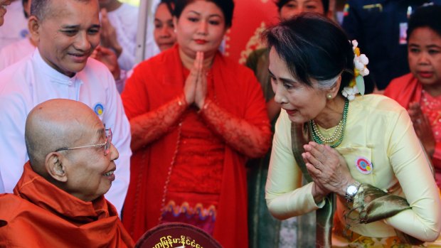 Myanmar State Counsellor and Foreign Minister Aung San Suu Kyi, right, pays respect to a monk during a ceremony at Upatasanti Pagoda earlier this month.