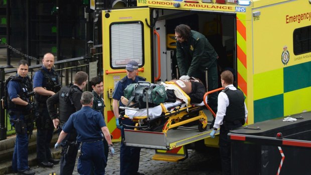 An attacker is treated by emergency services outside the Houses of Parliament in London.