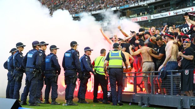 Wanderers fans let off flares during Saturday's A-League match between Melbourne Victory and Western Sydney Wanderers at Etihad Stadium.