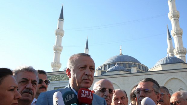 Recep Tayyip Erdogan speaks to the media outside a mosque after the Eid al-Fitr prayers in Istanbul, early on Sunday.