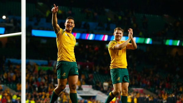 Hard-earned win: Israel Folau and Drew Mitchell celebrate their victory over Wales at Twickenham.
