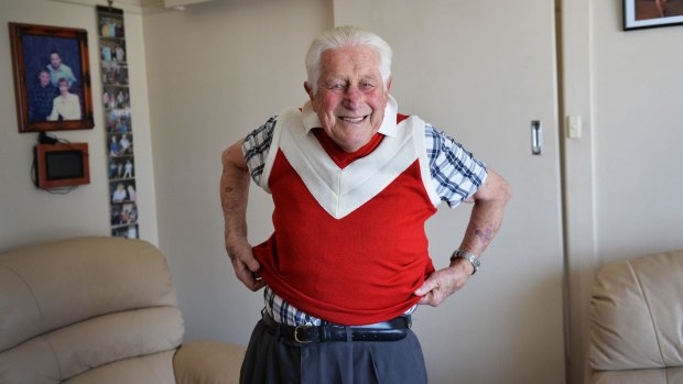 Vernon McKane, 82, pulls on a Metro Farm Football Club/Cocoroc Football Club jumper for the first time in more than 50 years. 