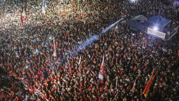 Anti-impeachment protesters attend a rally in Rio while former president Lula speaks.