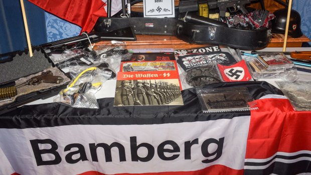Numerous weapons and items with banned Nazi symbols on display at a police news conference in Bamberg, Germany, on Thursday.