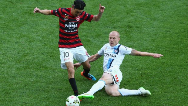 Aaron Mooy of Melbourne City challenges Yojiro Takahagi of the Western Sydney Wanderers.
