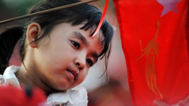 A young child with an NLD flag at the final rally attended by party leader Aung San Suu Kyi on Sunday.
