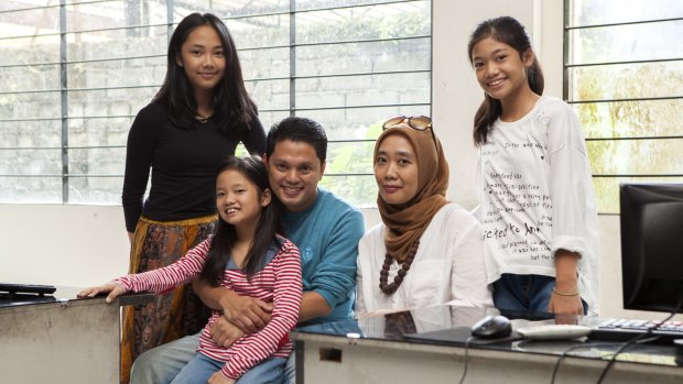 Muhammad Nur Rizal and his wife Novi Poespita Candra (both seated) with their daughters (from left), Nur Aliya Zahra, Soraya Syakieb, and Jaeza Amalina. The girls attended Clayton North Primary when living in Melbourne and their parents were stunned at the differences in Australian teaching methods compared with Indonesian schools. 